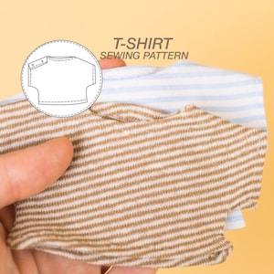 May include: A close-up of two striped t-shirts, one brown and white and one blue and white. The brown and white t-shirt is on top and the blue and white t-shirt is underneath. The image includes a diagram of a t-shirt sewing pattern with the text "T-SHIRT SEWING PATTERN".