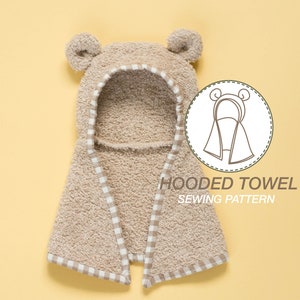 May include: A beige hooded towel with a white and beige checkered trim. The towel has bear ears and the text "HOODED TOWEL SEWING PATTERN" is printed below the towel.