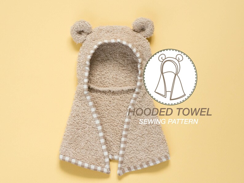 May include: A beige hooded towel with a white and beige checkered trim. The towel has bear ears and the text "HOODED TOWEL SEWING PATTERN" is printed below the towel.