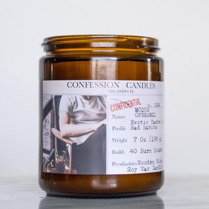 May include: A brown glass jar candle with a label that reads "CONFESSION CANDLES." The label includes the text "CONFIDENTIAL," "MODUS OPERANDI," and "Exotic Taste." The candle weighs 7 oz (198 g) and has a 40-hour burn time.