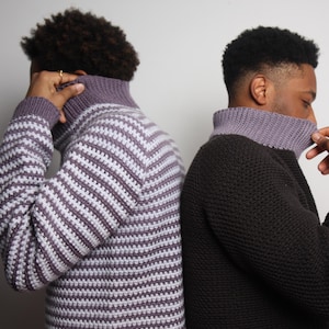May include: Two men wearing different knit sweaters. One sweater is striped in purple and white, the other is black with a purple collar.