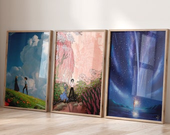 May include: Three framed prints of scenes from animated films. The first print features a blue sky with a white cloud and two figures walking on a green field. The second print shows a pink and green landscape with a castle in the background. The third print depicts a dark blue night sky with a shooting star and a figure standing on a beach.