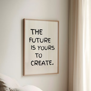 May include: A framed print with the text "THE FUTURE IS YOURS TO CREATE." hanging on a white wall above a bed with beige linens.
