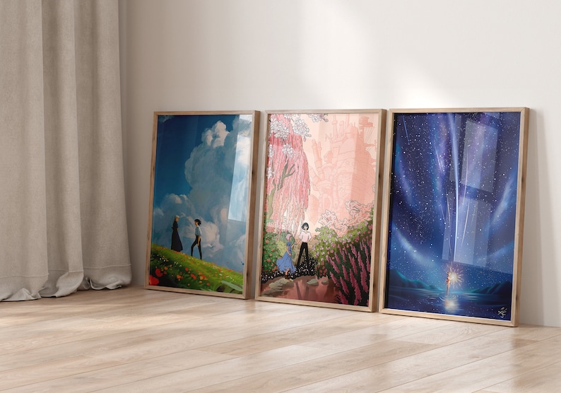 May include: Three framed prints of scenes from animated films. The first print features a blue sky with a white cloud and two figures walking on a green field. The second print shows a pink and green landscape with a castle in the background. The third print depicts a dark blue night sky with a shooting star and a figure standing on a beach.