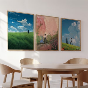 May include: Three framed art prints with a nature theme. The first print shows a green field with a single figure walking away from the viewer. The second print shows a couple walking through a field of flowers. The third print shows a couple walking through a field with a large cloud in the sky.