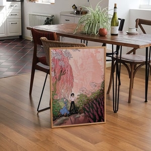 May include: A framed print of a cartoon illustration depicting two people walking through a pink and green landscape. The illustration features a large, pink, floating castle in the background.