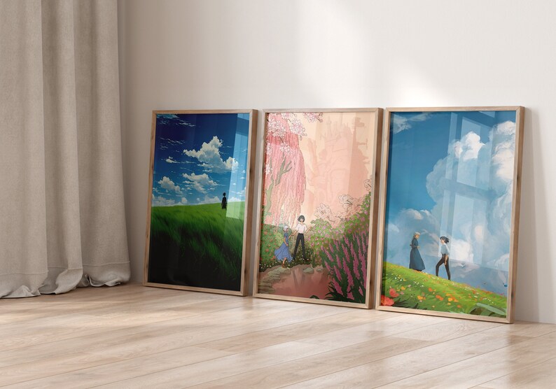 May include: Three framed prints with different scenes from the animated film Howl's Moving Castle. The first print shows a green field with a blue sky and white clouds. The second print shows a pink and purple garden with a couple walking through it. The third print shows a green field with a blue sky and white clouds, with a couple walking in the distance.