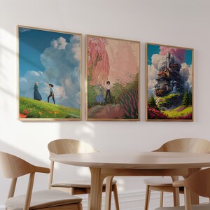May include: Three framed art prints with a white background. The first print features a blue sky with a white cloud and two figures walking in a field of flowers. The second print features a pink and green landscape with a figure walking in a field of flowers. The third print features a whimsical, colorful building with a cloud and smoke coming from the chimney.