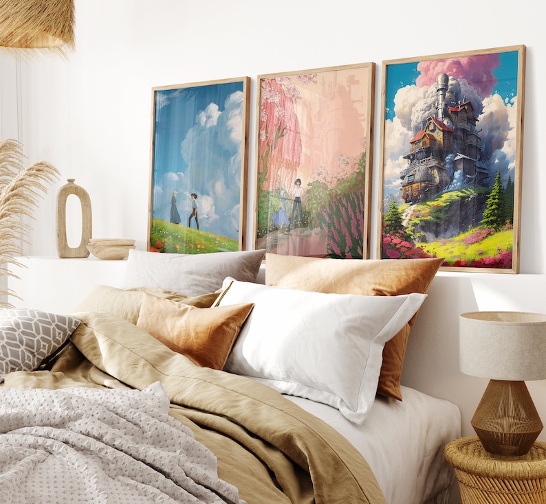 May include: Three framed art prints with a whimsical theme. The prints feature a floating house, a couple walking in a field, and a pink and green landscape. The prints are displayed on a white wall above a bed with brown bedding.