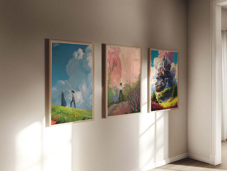 May include: Three framed art prints on a white wall. The left print shows a couple walking in a field of flowers. The middle print shows a pink and green landscape with a figure in the distance. The right print shows a floating house in the clouds.