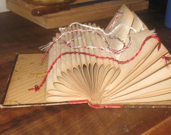 Folded book decorated with metallic threads