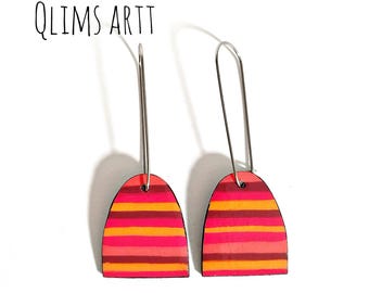 May include: A pair of handmade earrings with a colorful, striped design. The earrings feature a curved, rectangular shape with horizontal stripes in shades of pink, orange, and red. The text "QLIMS ARTT" is visible in the image.