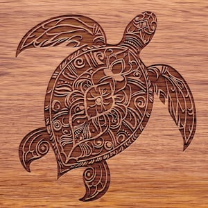 May include: A detailed wooden carving of a sea turtle. The turtle is intricately designed with swirling patterns and floral elements. The wood has a warm, reddish-brown tone, and the carving is set against a wood grain background.