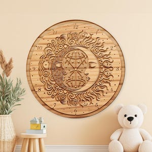 May include: A round wooden wall clock featuring a detailed sun and moon design. The clock face has carved numerals and intricate patterns, with the sun on the right and the moon on the left. The clock is made of light-colored wood.