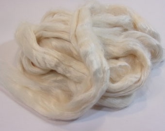 May include: A pile of white silk fibers, soft and fluffy, perfect for spinning or felting.