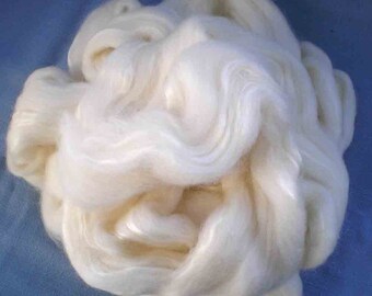 May include: A large clump of white, fluffy fiber. The fiber is soft and appears to be natural.