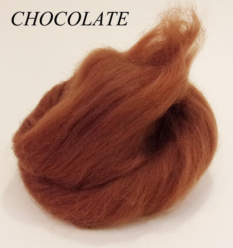 May include: A close-up of a bundle of brown wool roving, labeled "CHOCOLATE".