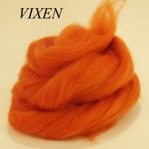 May include: A pile of orange wool roving, labeled "VIXEN".