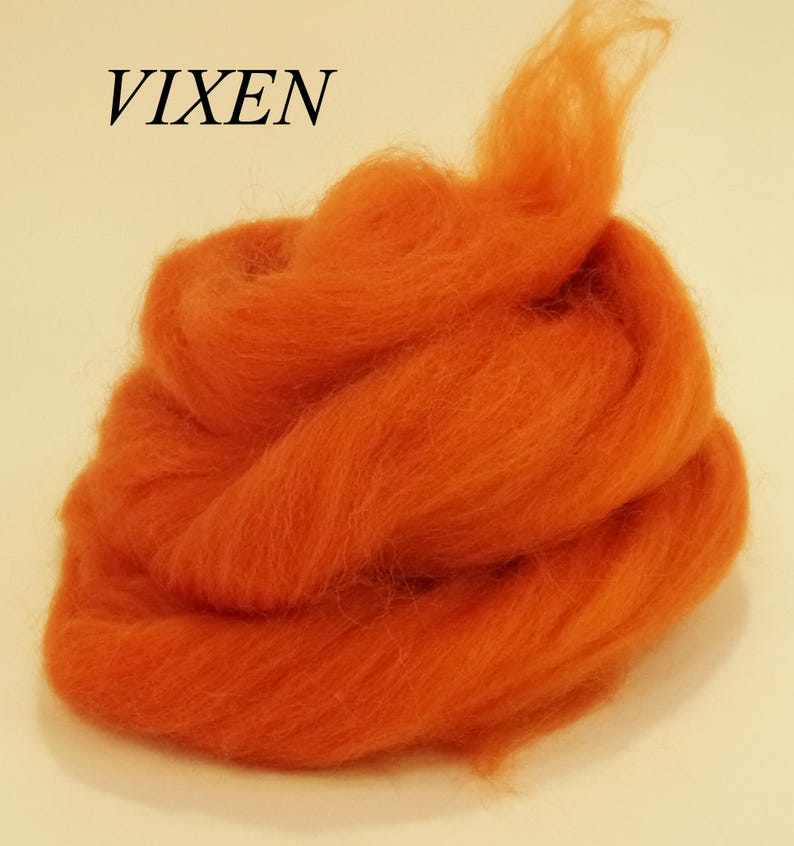 May include: A pile of orange wool roving, labeled "VIXEN".
