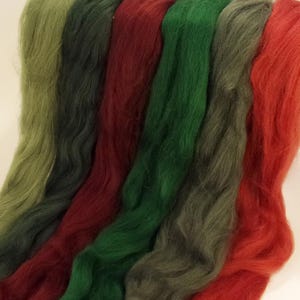 May include: Five strands of wool yarn in shades of green and red. The yarn is soft and fluffy, perfect for knitting or crocheting.