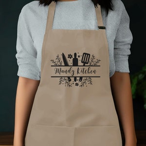 a woman wearing an apron with the words wendy's kitchen on it