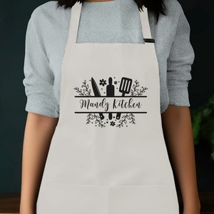 a woman wearing an apron with the words randy's kitchen on it