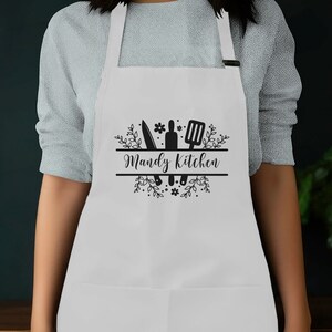 a woman wearing an apron with the words randy's kitchen on it