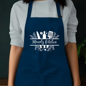 a woman wearing an apron with the words wendy's kitchen on it