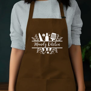 a woman wearing an apron with the words wendy's kitchen on it