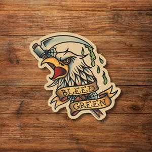 May include: A vintage-style sticker featuring a bald eagle with a green dripping scythe and a banner that reads "BLEED GREEN".