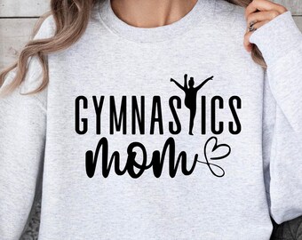 May include: A gray sweatshirt with the text "GYMNASTICS MOM" in black lettering with a heart and a silhouette of a gymnast.