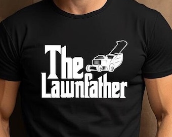May include: Black t-shirt with the white text "The Lawnfather" and a lawnmower graphic. The shirt is a crew neck style and is being worn by a person.