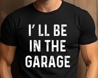 May include: A black t-shirt with white text that reads "I'll be in the garage".