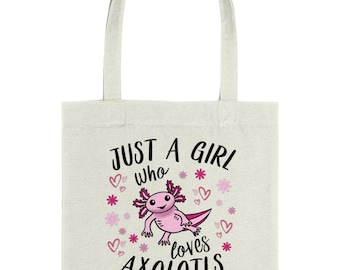 May include: A white tote bag featuring a pink axolotl illustration and the text "Just a girl who loves axolotls" in black. The design incorporates pink hearts and flowers.