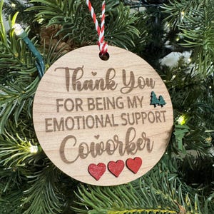 May include: Wooden Christmas ornament with the text "Thank You For Being My Emotional Support Coworker" and three red hearts.
