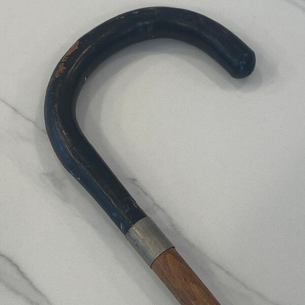 vintage walking stick with black handle, metal tip