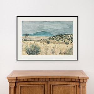 May include: A watercolor painting of a rural landscape with a windmill in the foreground, a distant mountain range, and a cloudy sky. The painting is framed in black.