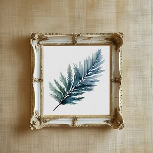 May include: A framed watercolor painting of a fern frond in shades of blue and green. The artwork is displayed in a white and gold ornate frame, mounted on a textured beige wall. The painting's botanical theme adds a touch of nature-inspired decor.