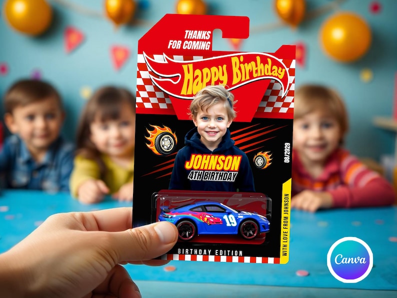 May include: A blue toy car with the number 19 is displayed on a birthday card. The card features a child's photo, the text "Happy Birthday," and "Johnson 4th Birthday." The card is held in a person's hand.