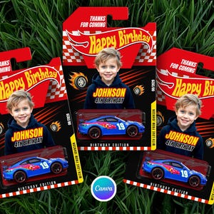 May include: Three toy car packages with a blue race car inside. Each package has a child's photo, the text "Happy Birthday," and "Birthday Edition." The packages are red and white.