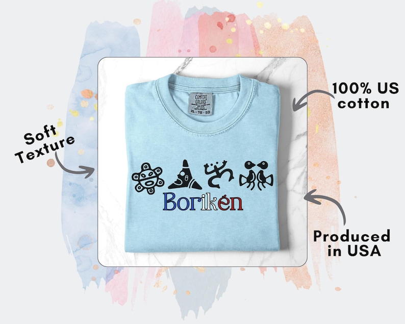 May include: Pale blue crew neck t-shirt with black graphic designs and the word "Borik&eacute;n" in blue and red. The shirt is made of 100% US cotton.