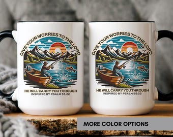 May include: Two white ceramic mugs with black handles and rims. Each mug features a colorful illustration of a fisherman in a boat, fishing on a lake with mountains and a sunset in the background. Text reads "Give Your Worries to the Lord" and "He Will Carry You Through."