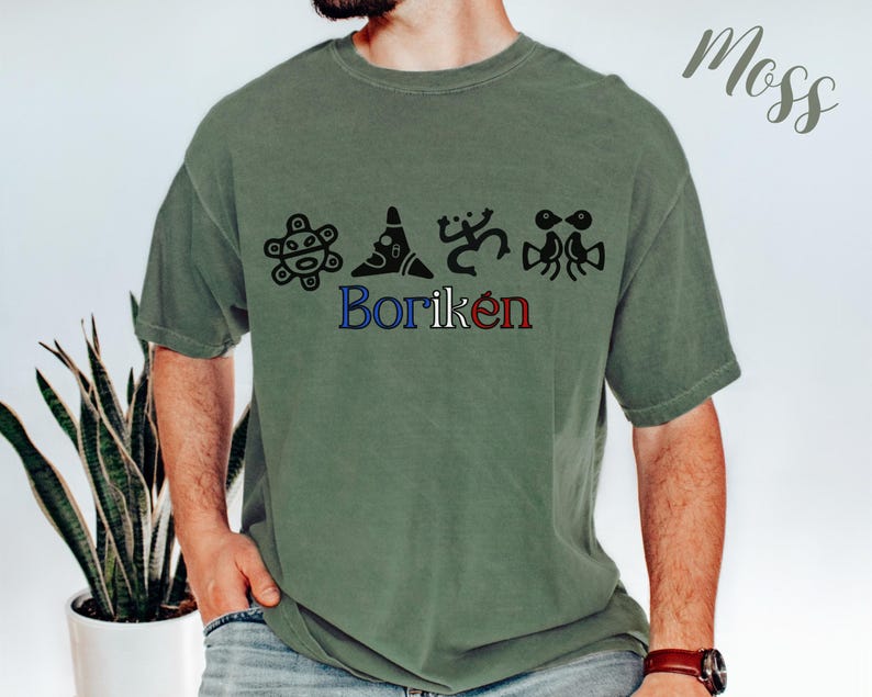 May include: A moss green t-shirt with black graphic designs and the word "Borik&eacute;n" in blue and red. The shirt has a relaxed fit and short sleeves. The word "Moss" is written in cursive in the upper right corner.