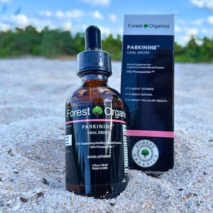 May include: A brown glass bottle with a dropper top labeled "Parkinine Oral Drops" by Forest Organics. The bottle is a natural supplement for supporting healthy mental function with Plaxoquantine. The bottle is sitting on a sandy surface.