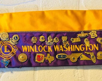 Lions Club Attendance pins and hat,  vintage late 60s early 70s.  43 pins from many different states and meetings