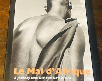 Le Mal d’ Afrique: A Journey Into Old and New Africa , Photographs and Texts by Guillaume Bonn,  1st Edition 2006 signed by the Author.