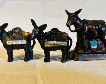 Three Souvenir burros, sold across the USA in the 1950s and 1960s,  Spelter plated with bronze.  From Modesto, CA, Colorado and Missouri.
