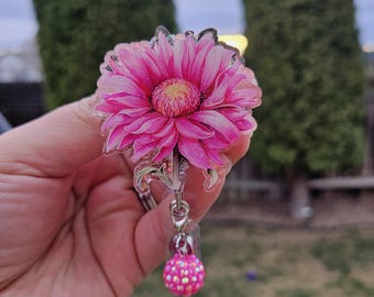 Daisy flower badge reel. Pink or rainbow color. Matching bead charm.