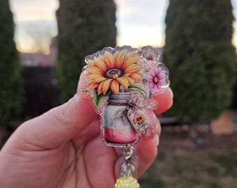 Flower badge reels. Glitter background. Matching bead gem.