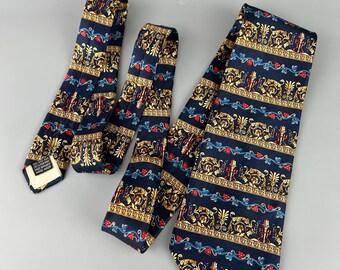 May include: Two silk ties with a navy blue background and a gold, red, and blue patterned design. The pattern features a repeating design of vines, leaves, and a stylised figure.